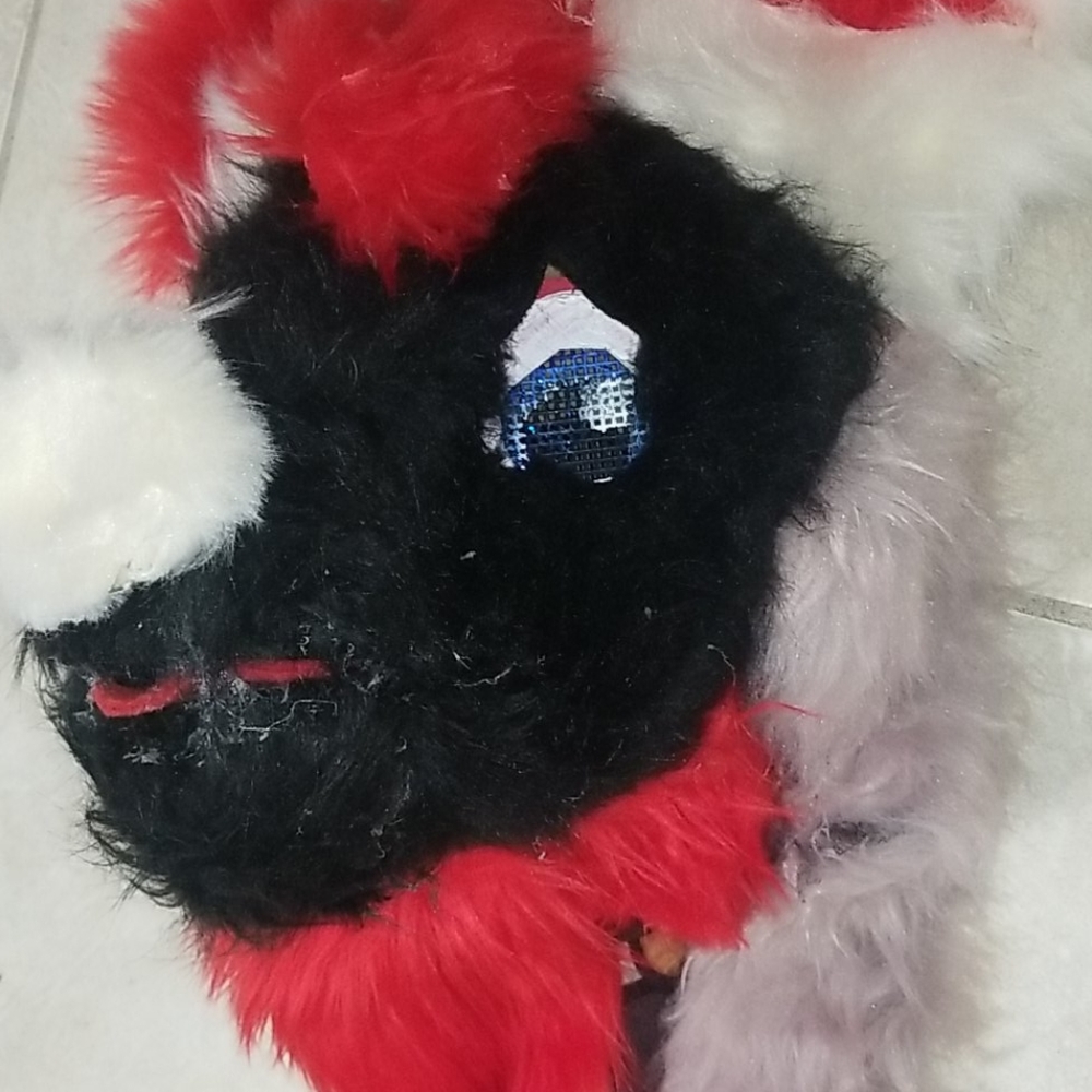 A fursuit head with hand paws and a tail